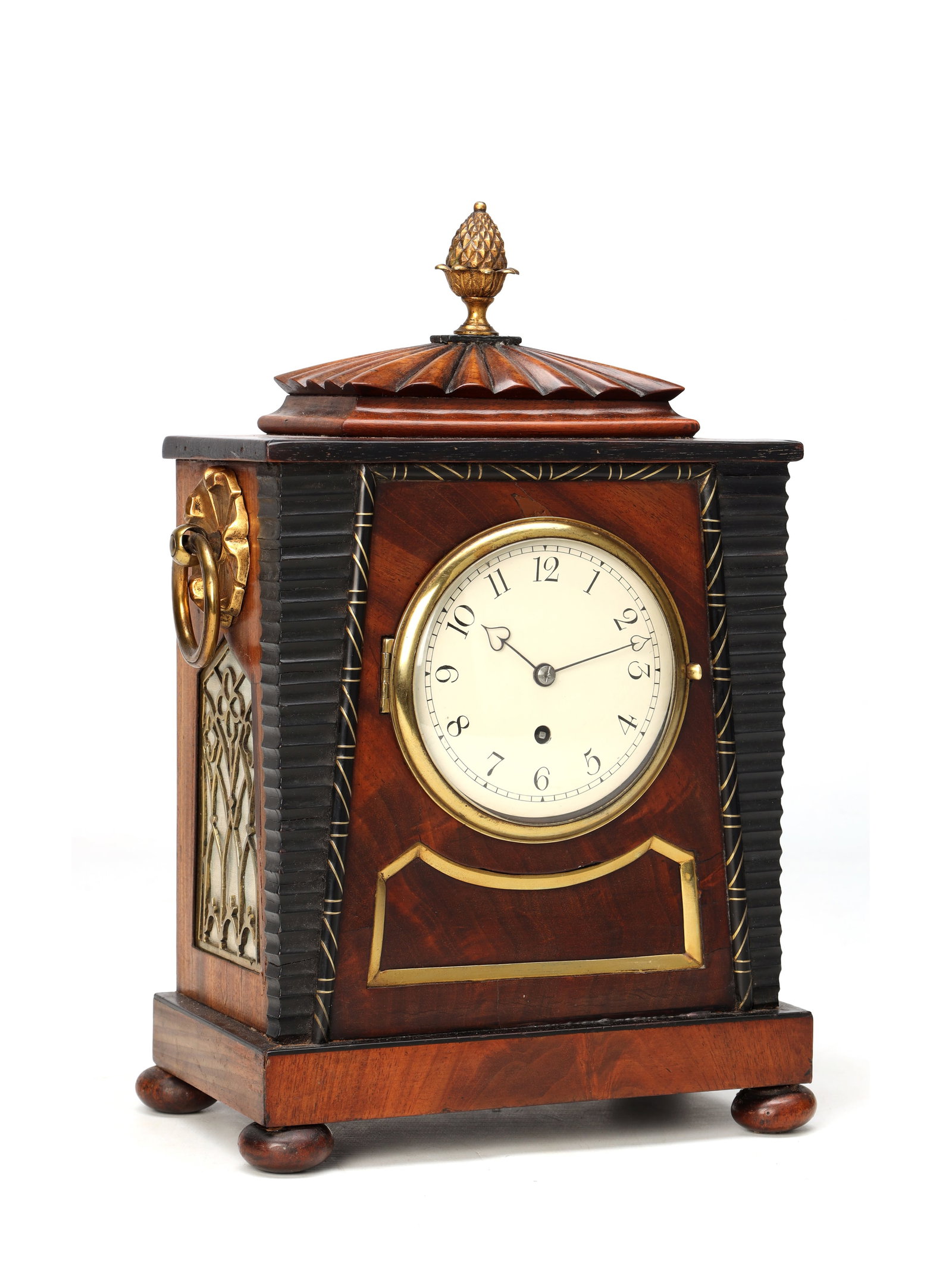 WILLIAM PAYNE, LONDON. A SMALL REGENCY EGYPTIAN STYLE MAHOGANY AND EBONISED FUSEE MANTEL CLOCK: WILLIAM PAYNE, LONDON. A SMALL REGENCY EGYPTIAN STYLE MAHOGANY AND EBONISED FUSEE MANTEL CLOCK of rectangular case with ebonised reeded angles, fluted domed top surmounted by a gilt pineapple finial, 