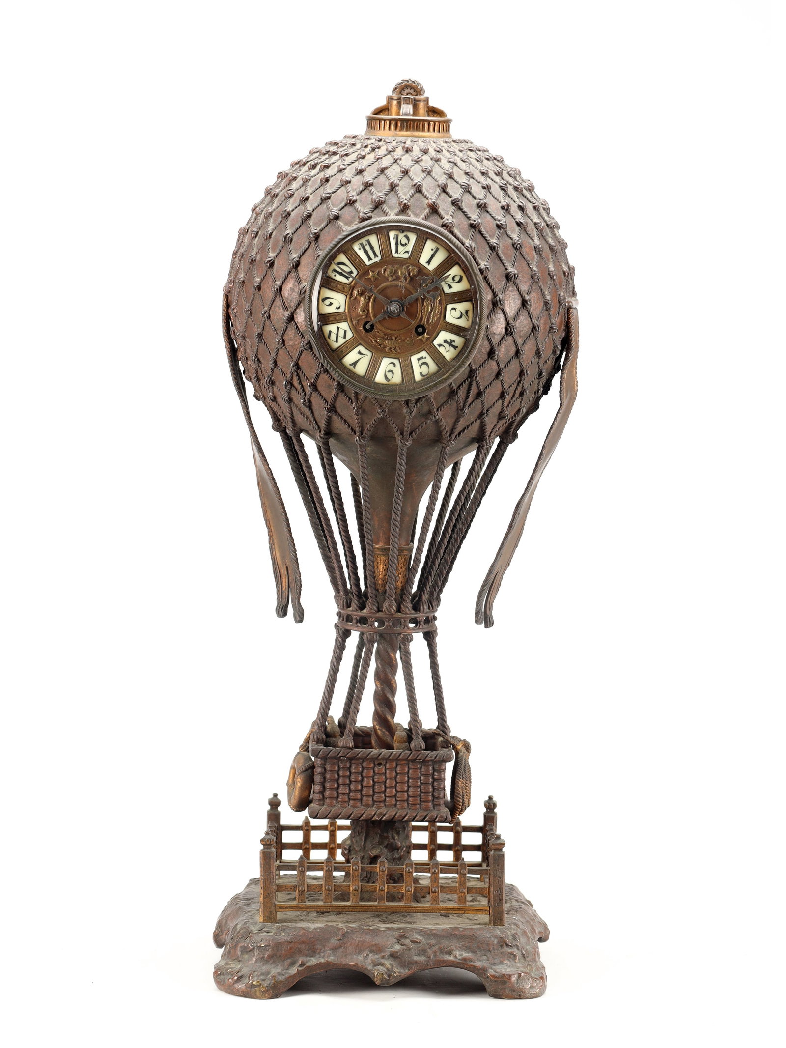 A LARGE AND RARE LATE 19TH CENTURY FRENCH PATINATED BRONZE BALLOONIST CLOCK: A LARGE AND RARE LATE 19TH CENTURY FRENCH PATINATED BRONZE BALLOONIST CLOCK modelled as a hot air balloon with netted canopy and wicker basket, enclosing a 4 1/2' dial with enamel Arabic numerals, fro