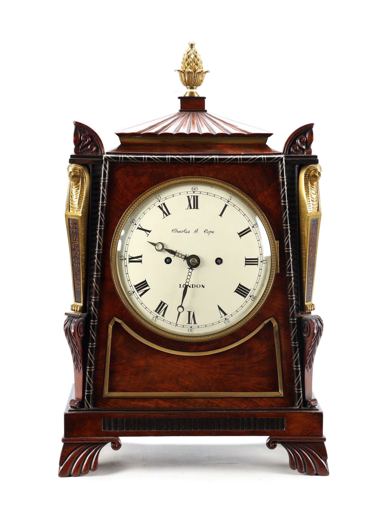 CHARLES COPE, LONDON A REGENCY FIGURED MAHOGANY EGYPTIAN DOUBLE FUSEE BRACKET CLOCK: CHARLES COPE, LONDON A REGENCY FIGURED MAHOGANY EGYPTIAN DOUBLE FUSEE BRACKET CLOCK the figured mahogany case with canted corners mounted with ormolu sphinxes and a ribbed caddy top with gilt urn fini