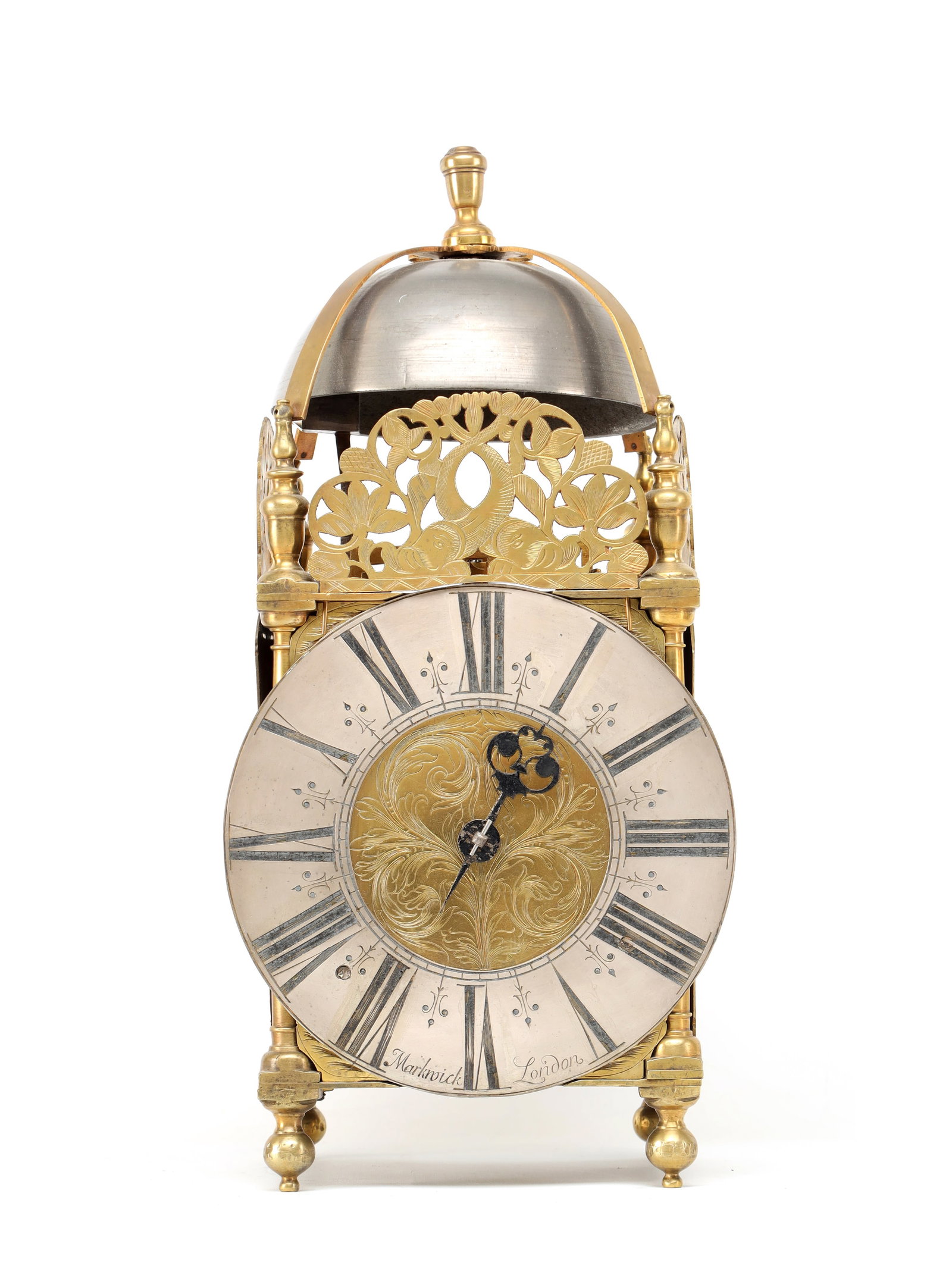 MARKWICK, LONDON. A WILLIAM AND MARY STRIKING VERGE LANTERN CLOCK: MARKWICK, LONDON. A WILLIAM AND MARY STRIKING VERGE LANTERN CLOCK the brass case with turned corner pillars, pierced foliate frets and domed bell with finial, on ball feet, enclosing a 6 3/4' silvered