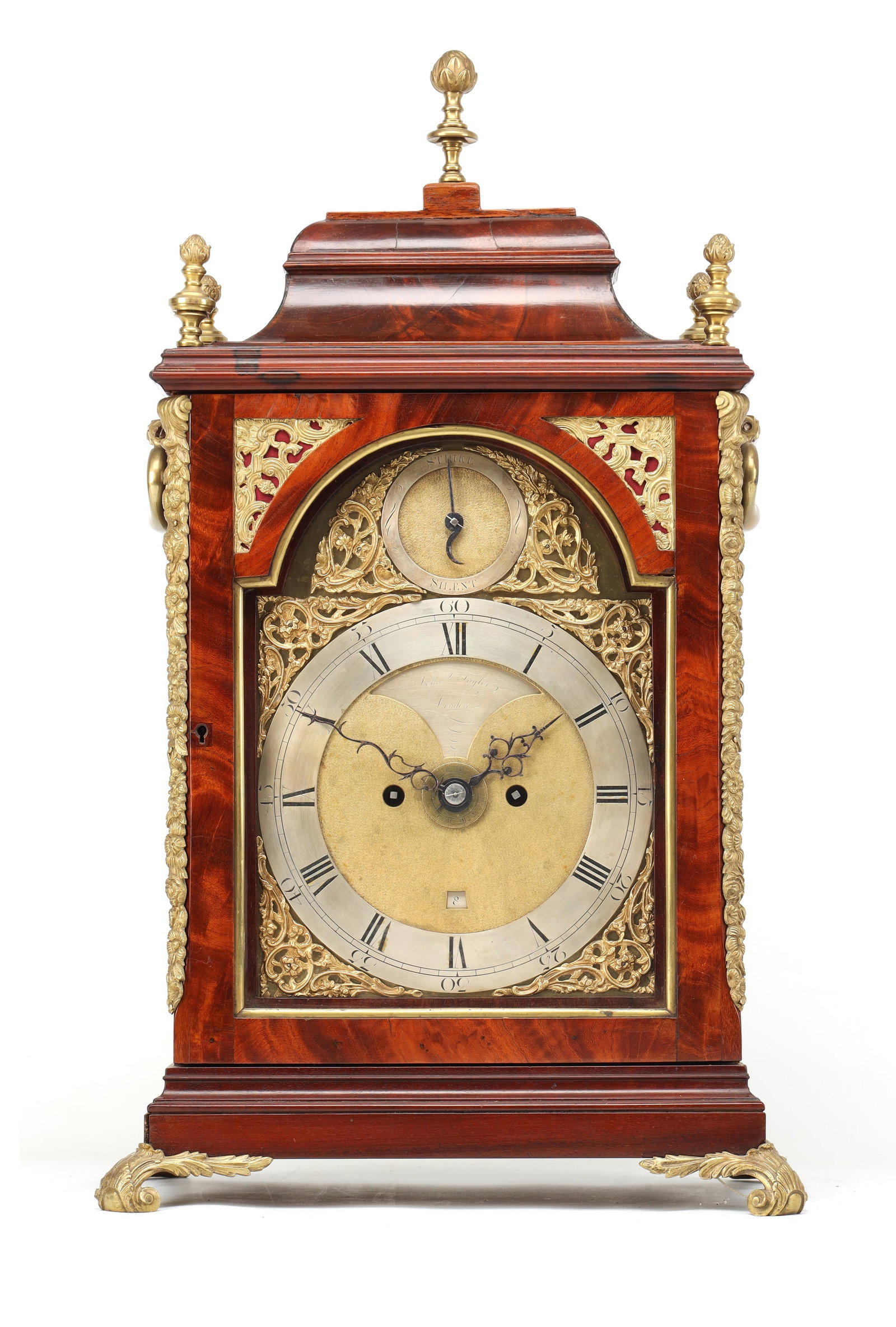 JOHN TAYLOR, LONDON. A GEORGE III ORMOLU MOUNTED FIGURED MAHOGANY VERGE BRACKET CLOCK WITH ALARM: JOHN TAYLOR, LONDON. A GEORGE III ORMOLU MOUNTED FIGURED MAHOGANY VERGE BRACKET CLOCK WITH ALARM the caddy top case with ormolu finials, gilt side handles and foliate cast feet enclosing an 8' arched 