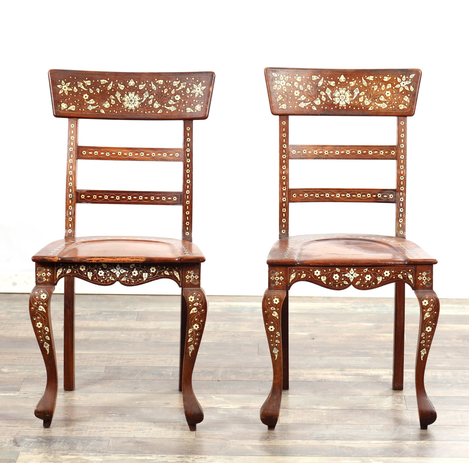 A PAIR OF LATE 19TH CENTURY ANGLO INDIAN INLAID BONE HARDWOOD SIDE CHAIRS: A PAIR OF LATE 19TH CENTURY ANGLO INDIAN INLAID BONE HARDWOOD SIDE CHAIRS having floral inlaid panelled backs, shaped seats and serpentine front rails, raised on cabriole front legs and square rear su