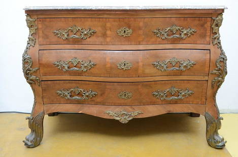 A Louis XV style chest of drawers with a marble top: A Louis XV style chest of drawers with a marble top (97x130x64cm) (*)