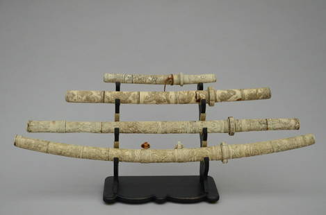 A collection of four Japanese swords in bone, circa 1900 (L 93/86/65/37cm) (*): A collection of four Japanese swords in bone, circa 1900 (L 93/86/65/37cm) (*)