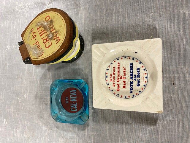 Lot of Vintage Ashtrays: We have a lot that includes 2 ashtrays 1 is an Archie Bunker ashtray from 1972 1 is a Reno Cal-Neva Casino ashtray and goodbye cruel world decrotive toliet