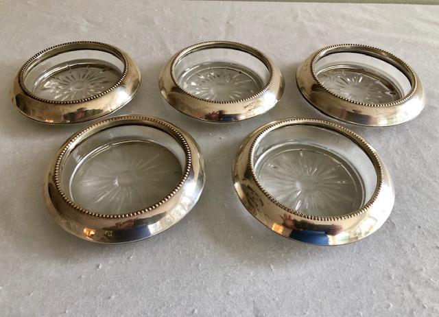 Frank M. Whiting Sterling Glass Coaster Set of 5: Frank M. Whiting Sterling Glass Coaster Set of 5. Sterling Silver overlay over glass. 3 3/4-inch Diameter, 3-inch inner Diameter.