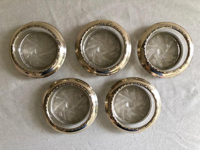 Amston Sterling Silver Glass Coaster Set of 5: Amston Sterling Silver Glass Coaster Set of 5. Sterling Silver overlay over glass. 4-inch Diameter, 3-inch inner Diameter.