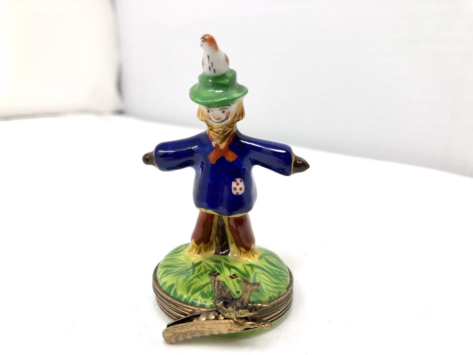 Limoges France Peint Main Scarecrow Trinket Box: Limoges France Peint Main Scarecrow Trinket Box. Approx. 1 1/2-inches Diameter by 3-inches Tall. As-is, as-shown.