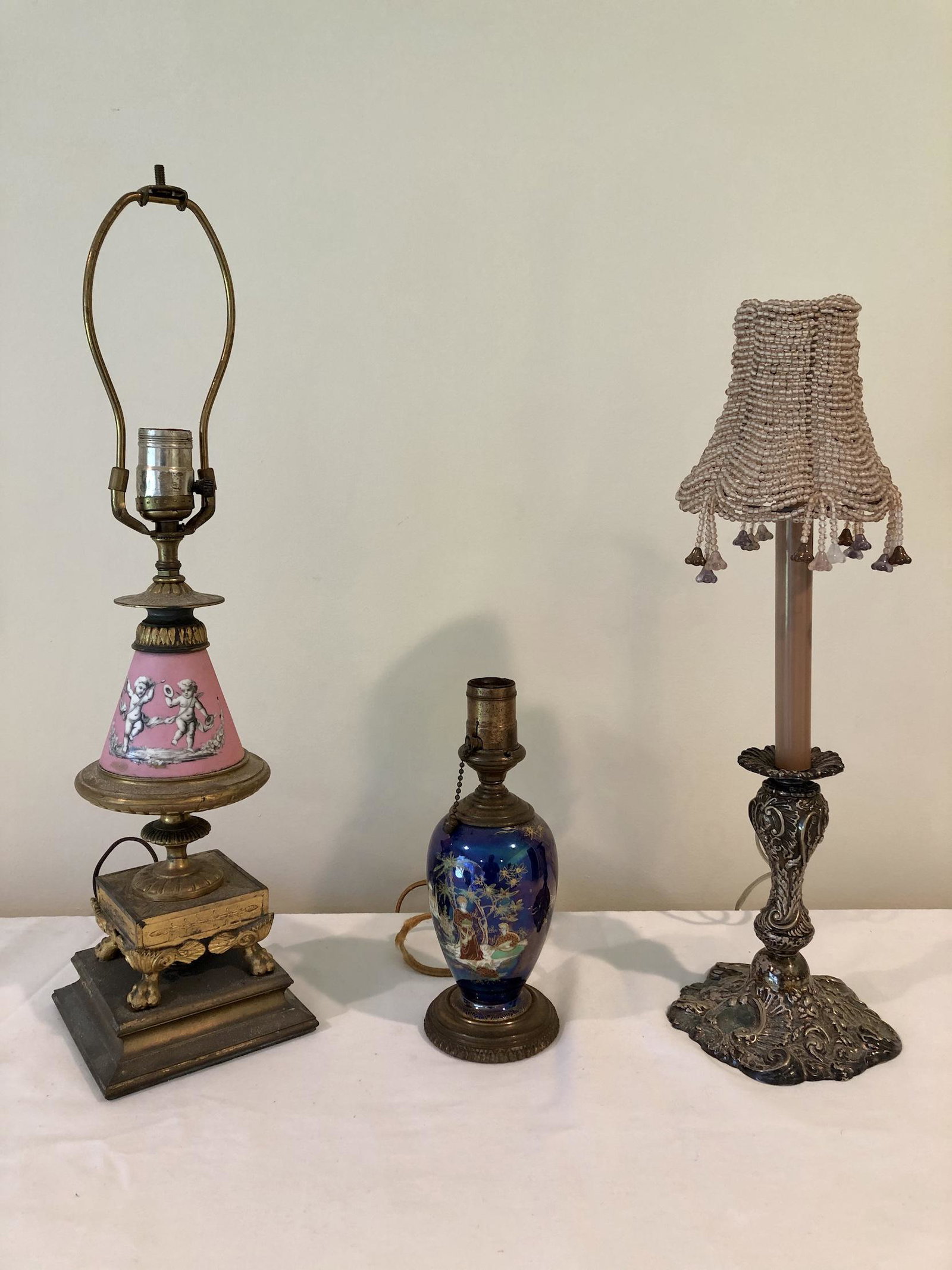 Vintage Antique Electric Table Lamp Lot of Three (3): Vintage Antique Electric Table Lamp Lot of Three (3). One Bisque Porcelain and Brass, One Oriental Vase Motif & One Silver Plate Candlestick Style. 10-inches to 22-inches High. May need to be re-wired