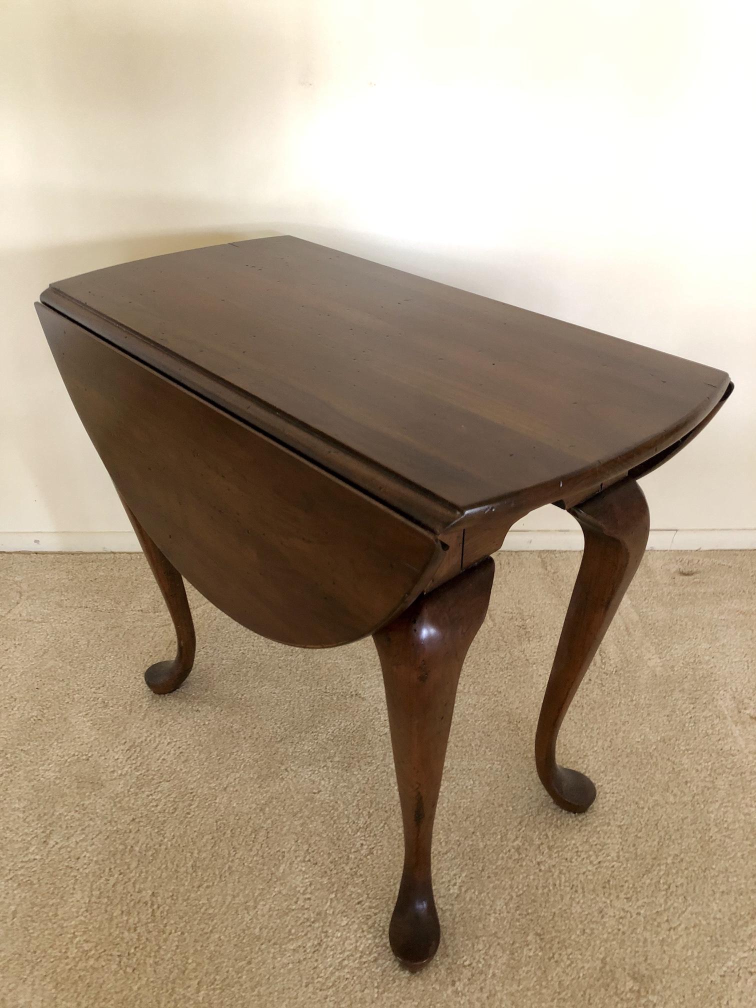 Queen Anne Style Oval Drop Leaf Side End Table: Queen Anne Style Oval Drop Leaf Side End Table. Approx. 15 by 28-inches in dimension. 24-inches in height. 28 by 32 1/2-inches Extended. As-Is, As-Shown from an estate. In vintage, as-found estate con