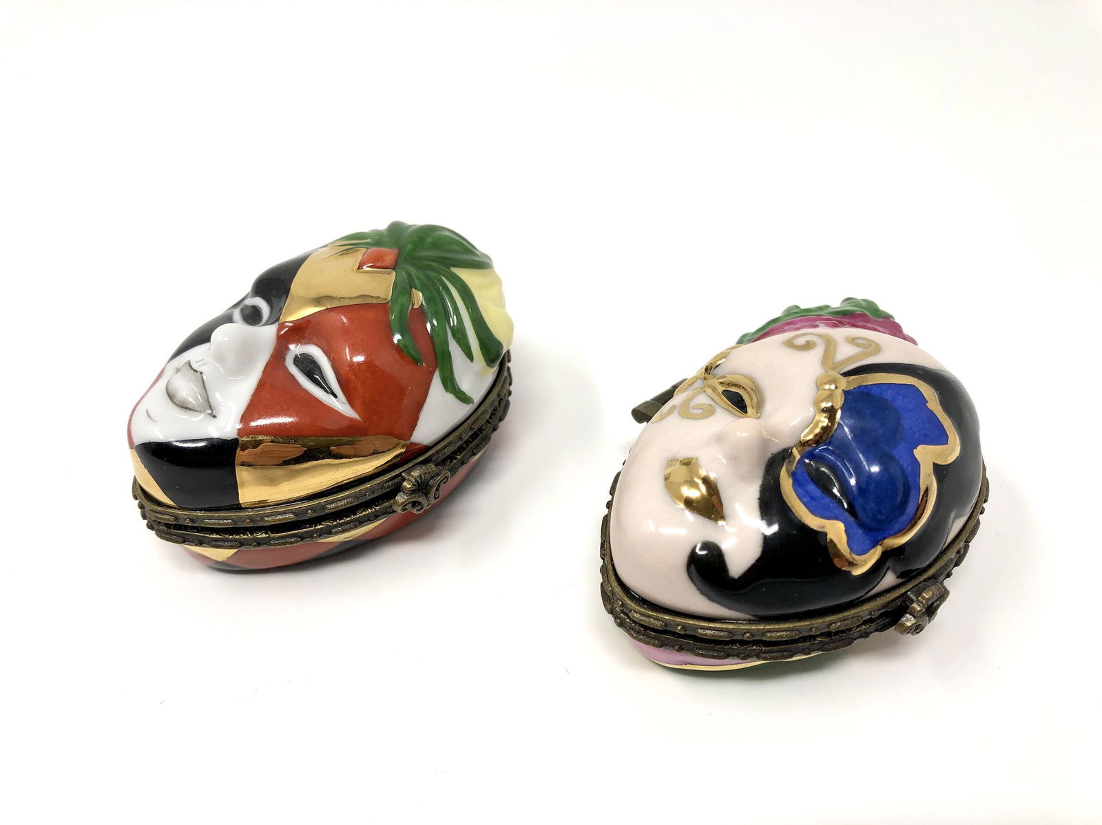 Harlequin Masquerade Mask Pair of Two Trinket Boxes: Harlequin Masquerade Masks Pair of Two Peint Main Limoges France Porcelain Trinket Boxes. Hand painted. Approx. 1 3/4-inches Tall by 1 3/4 by 2 1/2-inches In Dimension. In beautiful as-is, as-shown co