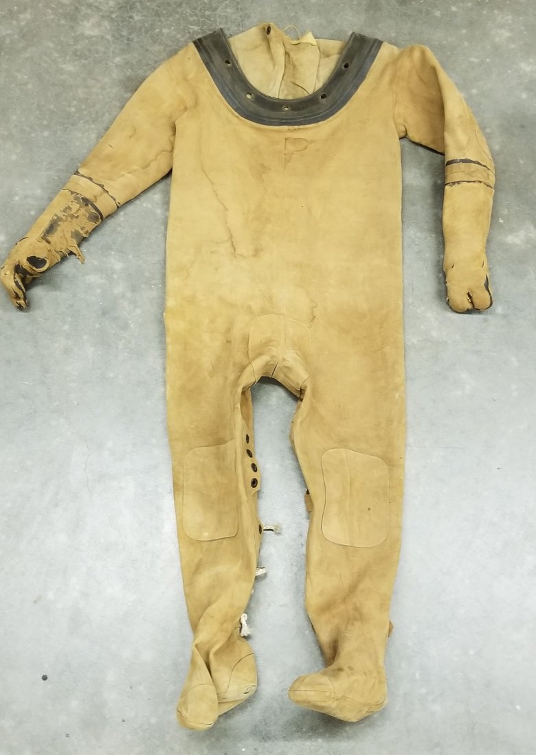 1945 US Navy Mark V Diving Helmet Dress Suit: This is the classic canvas divers dress or suit for the famed Mark V. This suit was made in April of 1945 by United States Rubber Company. This suit is a size 3. The suit was part of a diving companie