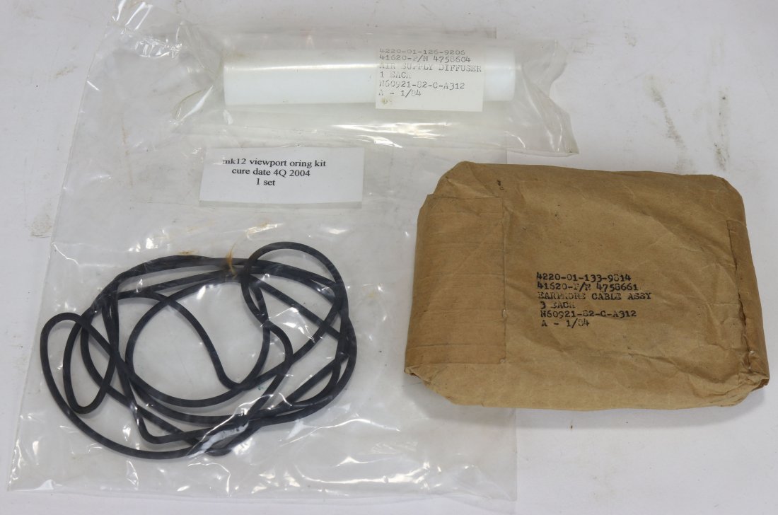 US Navy Mark 12 Diving Helmet Parts Grouping 2: US Navy Mark 12 diving helmet parts grouping. This lot consists of new old stock sealed Earphone Cable Assembly 3, helmet viewport oring kit 1 set, 1 air supply diffuser. All items will be shipped wit