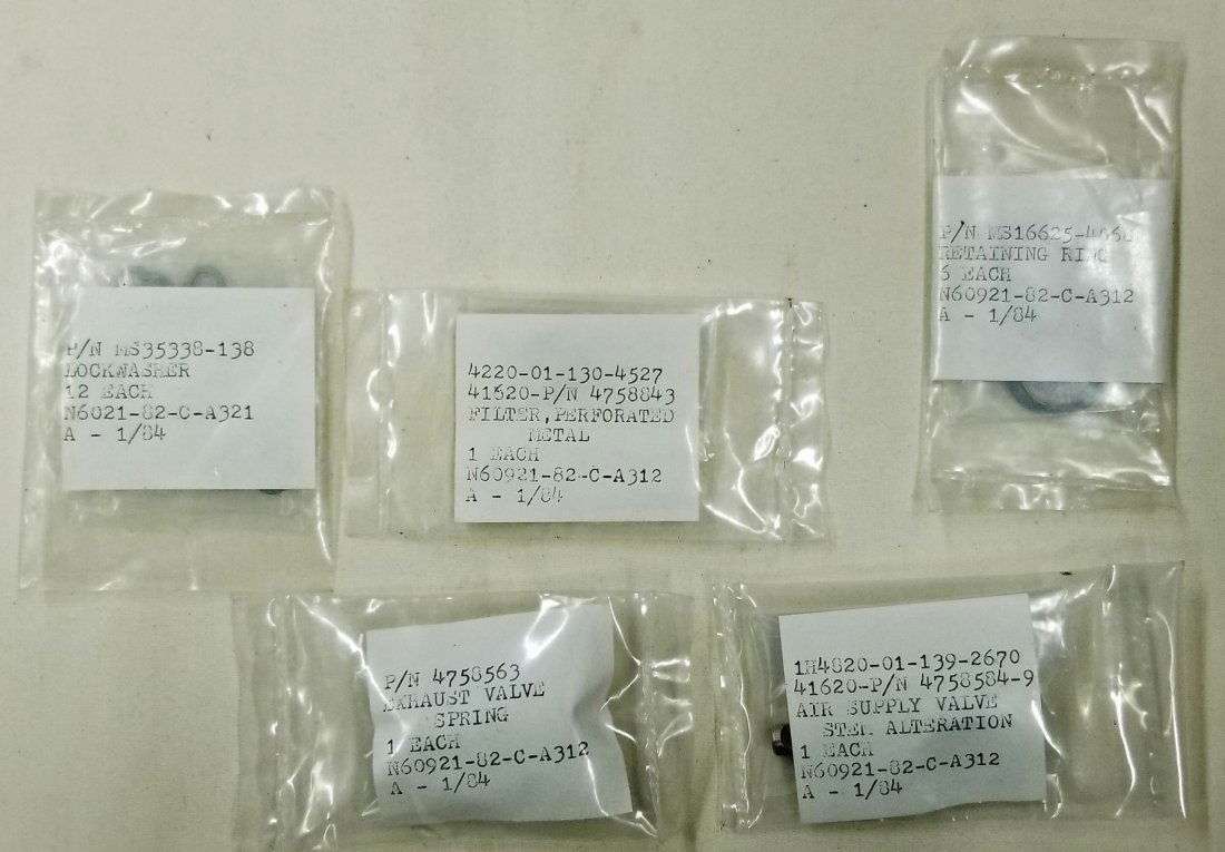 Mark 12 Diving Helmet Assorted NOS Parts Lot #1: Lot of 5 sealed packs of various Mark 12 diving helmet parts. Lock washers, perforated metal filter, retaining rings, exhaust valve spring, air supply valve stem. Items are all new old stock (NOS).