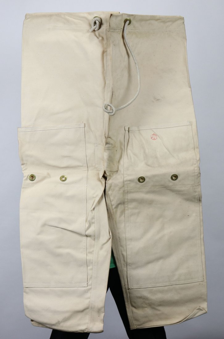 World War 2 US Navy Chafing Paints w/ Stamp: US Navy chafing paints used in conjunction with the Mark V diving helmet system. These pants are in incredible never used new old stock condition. The front left pocket features a red US Navy inspecti