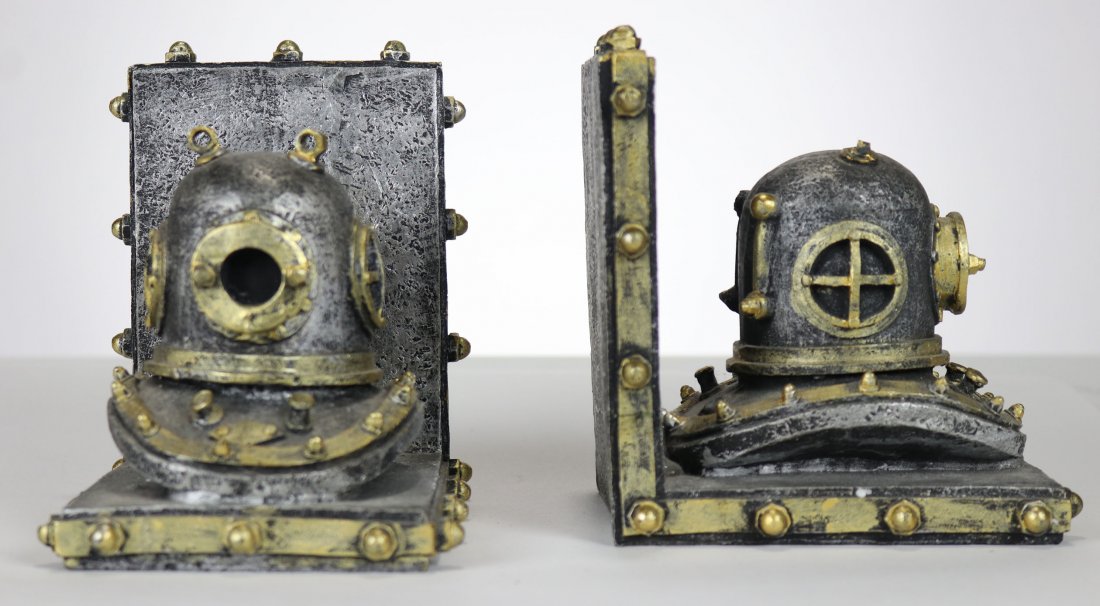 Pair of Antique Diving Helmet Book Ends: Great looking matching pair of antique diving helmet book ends. These are contemporary in age. The back side of one of the helmets does have a small chip, as shown in photos.