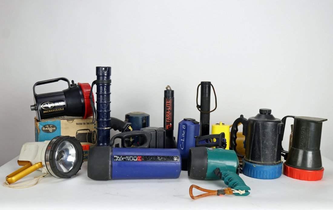Collection of 14 Underwater Scuba Diving Lights: Grouping of fourteen different vintage underwater diving lights. The collection consists of a Oceanic Productions Ocean Pro blue and black, Mini Light Splash by Dacor New in box, UK1200R Rechargeable 