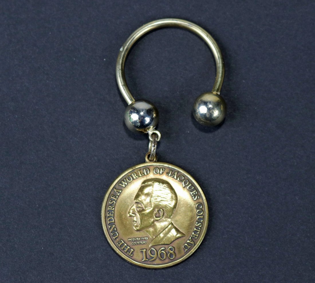 1968 Jacques Cousteau USD Aqua-Lung Keychain: Very nice U.S. Divers Company Aqua-Lung / Jacques Cousteau keychain. This was a dealer only piece that came out in 1968. Piece appears to be in like new condition. One side has The Undersea World of J