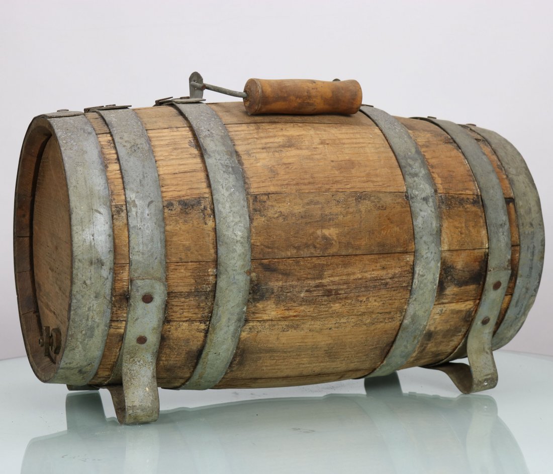 Antique Ships Wooden Water or Rum Keg: Great looking antique oak ships keg. These small kegs were used for water or rum on ships. Features small feet on the bottom, folding handle on top, brass valve on one end, brass bunghole cap on top. 