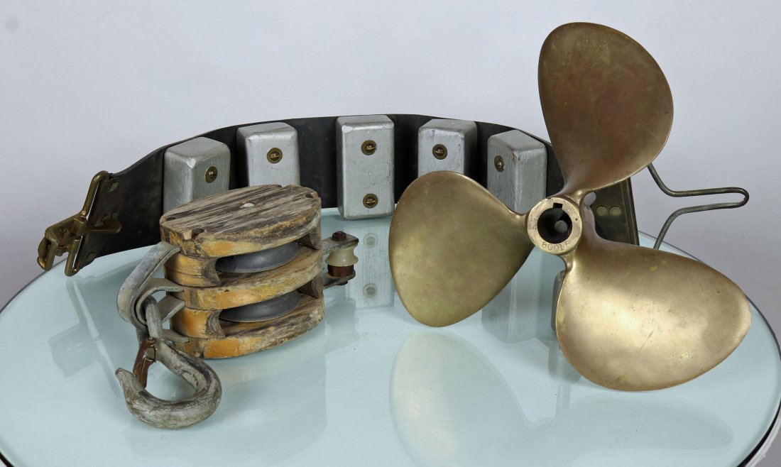 Brass Propeller, Homemade Rubber Belt and Ships Pulley: Collection of items from the Divers Academy International school. First item is a brass propeller which weighs 8 pounds and is 13 inches in diameter. Second is a homemade rubber belt with wood blocks 