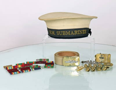 US & UK Submarine Uniform Memorabilia: This is a collection of authentic submariner uniform pieces. The first item is a English H.M. Submarines hat. Next is 20 campaign ribbons. Third is a belt buckle from the USS Alexandria SSN 757.