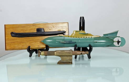 Three Vintage Submarine Model Grouping: This groping consists of 3 pieces. The first a green plastic submarine toy called the Atomico. It is in great condition and measures 17 inches long, weighs 1 pound 3 ounces. The second piece is a bras