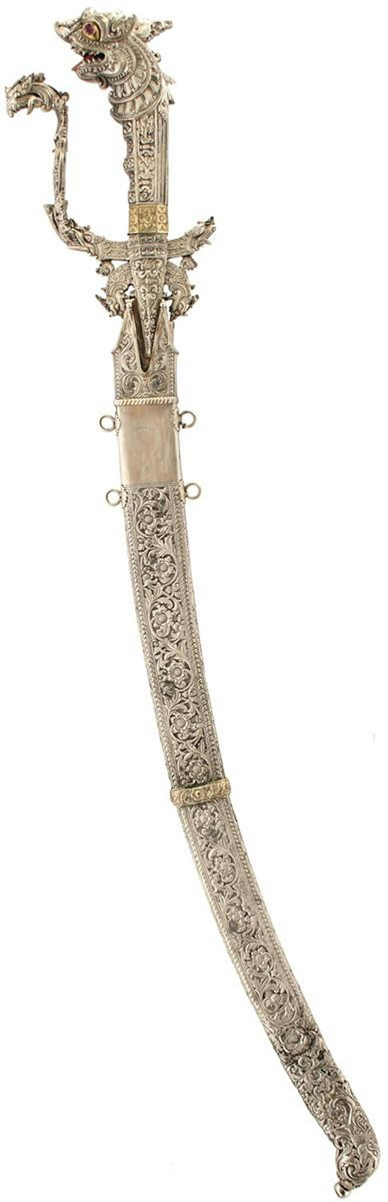 A SINHALESE OR CEYLONESE KASTANE OR SHORT SWORD: A SINHALESE OR CEYLONESE KASTANE OR SHORT SWORD, 34cm curved fullered blade with border and elaborately scroll engraved white metal reinforced forte, characteristic hilt finely decorated with scrollin