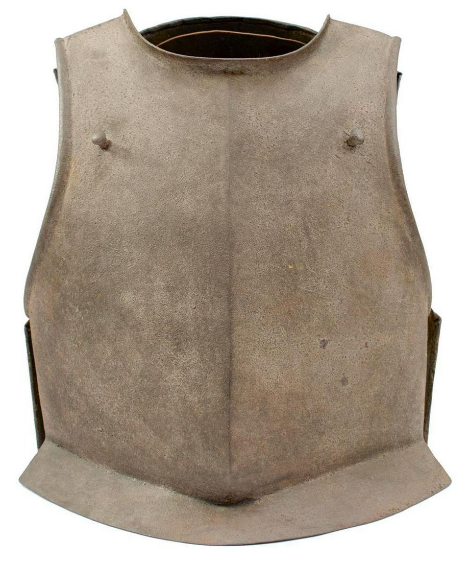 A 17TH CENTURY ENGLISH CIVIL WAR PERIOD PERIOD SIEGE: A 17TH CENTURY ENGLISH CIVIL WAR PERIOD PERIOD SIEGE WEIGHT BREAST PLATE, with central raised medial ridge drawn out to a rounded point, shallow flared skirt, turned arm and neck apertures, the associ