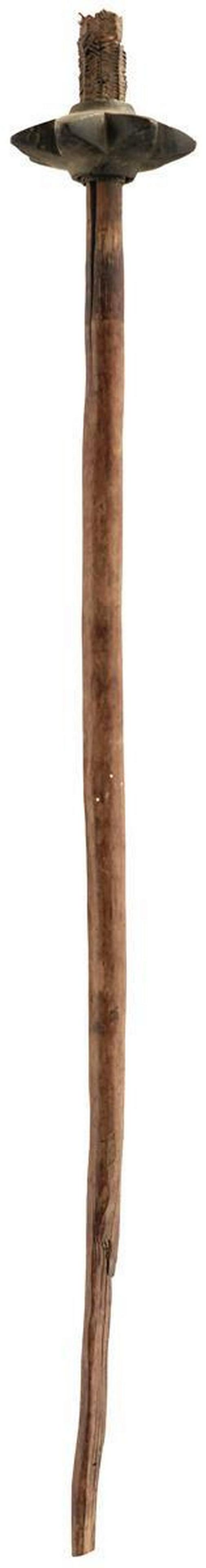 A LATE 18TH OR EARLY 19TH CENTURY PAPUA NEW GUINEA: A LATE 18TH OR EARLY 19TH CENTURY PAPUA NEW GUINEA STONE HEAD CLUB, the 11cm diameter carved stone head of star form with seven lobes and secured with a basket weave mesh above and below, characterist