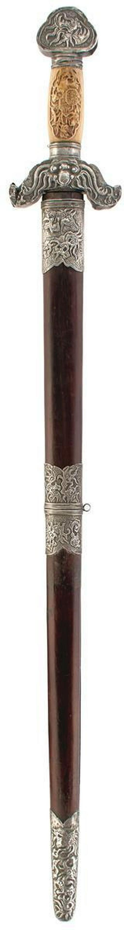 A LATE 19TH CENTURY VIETNAMESE KIEM OR SWORD, 57.5cm: A LATE 19TH CENTURY VIETNAMESE KIEM OR SWORD, 57.5cm double fullered blade chiselled with smoke and flames at the forte, characteristic white metal mounted hilt decorated with stylized dragons and dra