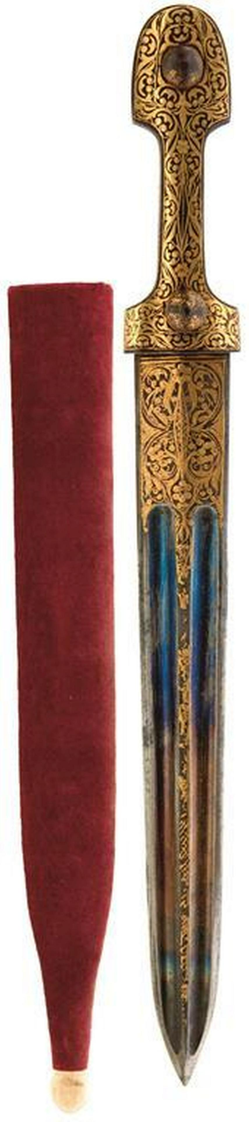 A 19TH CENTURY KINDJAL, 24cm double fullered blade with: A 19TH CENTURY KINDJAL, 24cm double fullered blade with traces of blued finish, the forte and raised medial rib decorated with scrolling foliage in gold koftgari, characteristic hilt decorated to matc