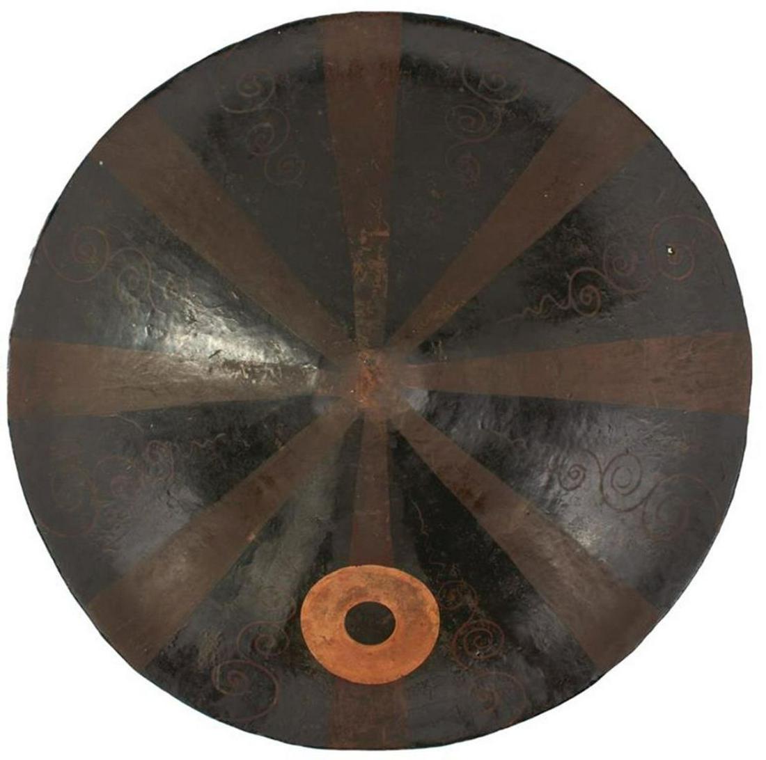 A 19TH CENTURY JAPANESE JINGASA OR WAR HAT, 39cm: A 19TH CENTURY JAPANESE JINGASA OR WAR HAT, 39cm diameter lacquered papier mache body of dished concave form drawn out to a rounded peak and decorated with stripes, scrolls and a pierced circular Mon,