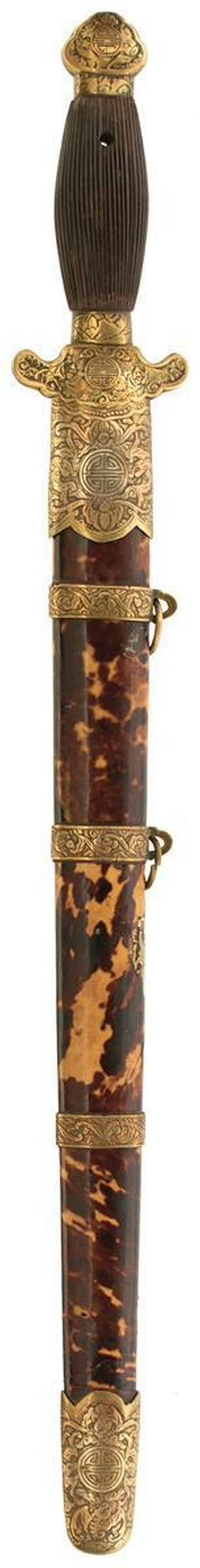A 19TH CENTURY CHINESE SWORD: A 19TH CENTURY CHINESE SWORD, 41cm flattened diamond section blade, characteristic brass mounted hilt decorated with foliage and characters, reeded wooden grip, contained in its brass mounted tortoise