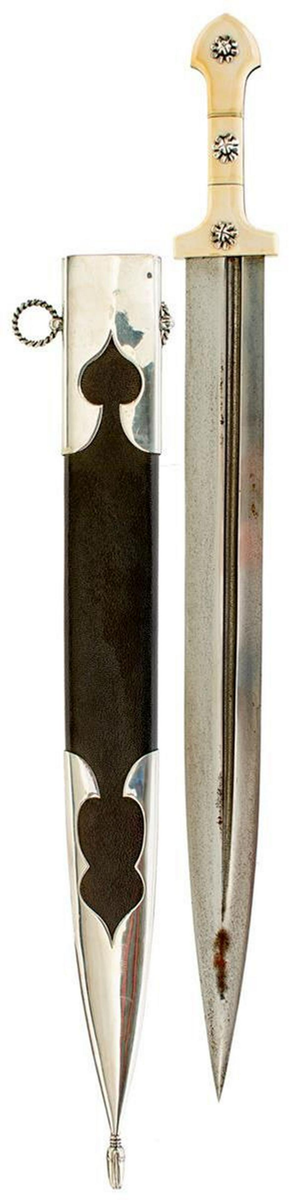 A LATE 19TH OR EARLY 20TH CENTURY LARGE SIZE CAUCASIAN KINDJAL: A LATE 19TH OR EARLY 20TH CENTURY LARGE SIZE CAUCASIAN KINDJAL, 53cm blade with deep offset fuller to either side, characteristic hilt with two-piece riveted ivory grips, white metal mounted leather w
