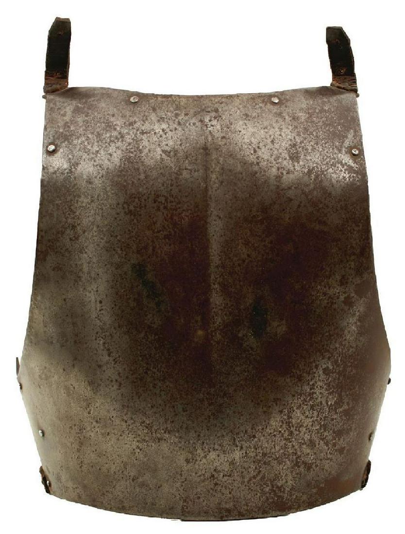 AN EARLY 18TH CENTURY GERMAN BACK PLATE, the shaped plate body with central gulley and concealed: AN EARLY 18TH CENTURY GERMAN BACK PLATE, the shaped plate body with central gulley and concealed turned edges, riveted, reinforced shoulders and sides, original leather shoulder and waist straps.