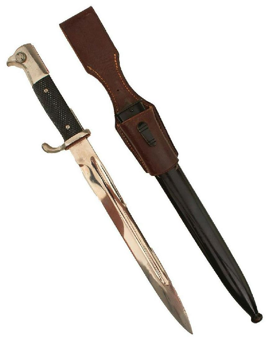 A THIRD REICH DRESS BAYONET, 25cm clean fullered plated blade, regulation plated hilt with chequered: A THIRD REICH DRESS BAYONET, 25cm clean fullered plated blade, regulation plated hilt with chequered riveted grips, contained in its black painted steel scabbard, complete with leather frog.