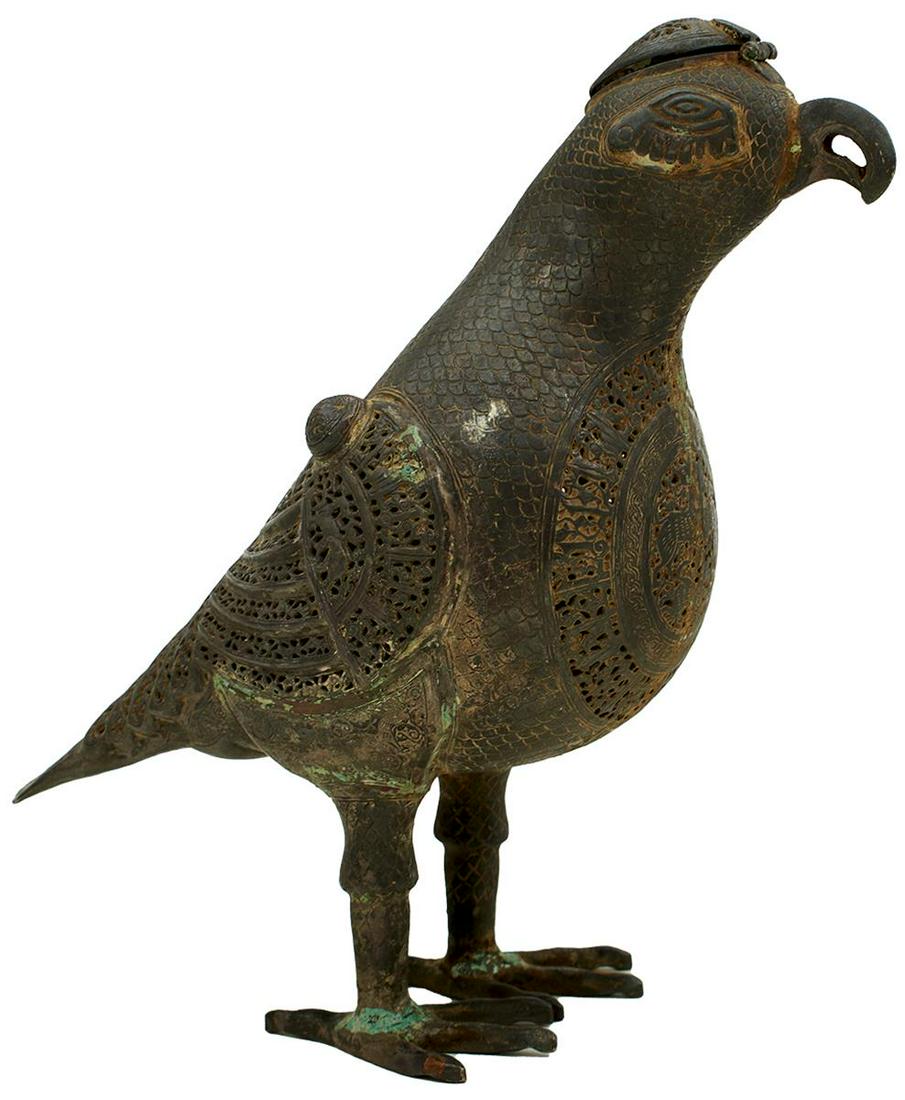 A MIDDLE EASTERN SILVER CHASED INCENSE BURNER IN THE FORM OF A FALCON, PERSIA 19TH CENTURY, the bird: A MIDDLE EASTERN SILVER CHASED INCENSE BURNER IN THE FORM OF A FALCON, PERSIA 19TH CENTURY, the bird free standing, with pierced hinged lid to the top of its head, with feather details and panels of a