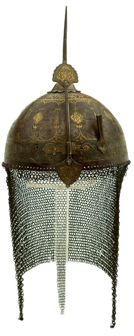 A LATE 18TH OR EARLY 19TH CENTURY INDO-PERSIAN KULAH KHUD OR HELMET, the bowl profusely chiselled: A LATE 18TH OR EARLY 19TH CENTURY INDO-PERSIAN KULAH KHUD OR HELMET, the bowl profusely chiselled with panels of scrolling foliage and flowerheads within borders of scrolling foliage and geometric des