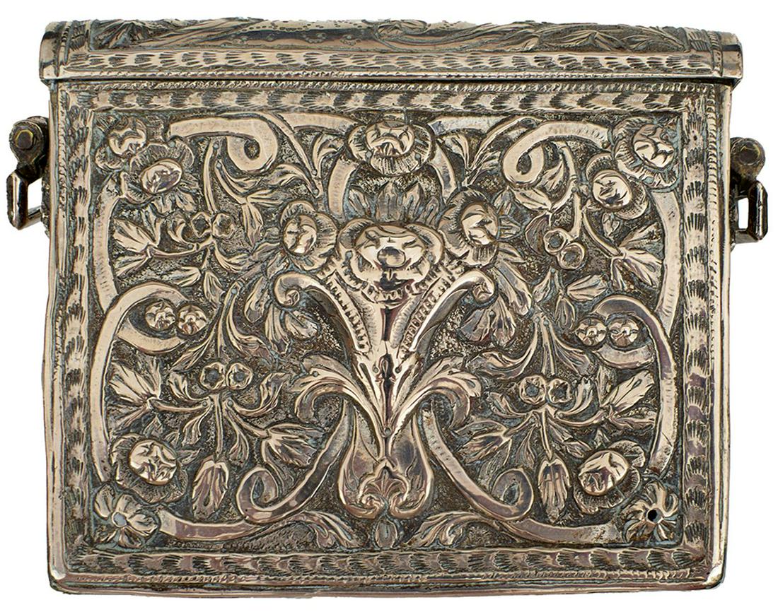 A 19TH CENTURY BALKAN CARTRIDGE BOX, of characteristic form, embossed to the front and top with: A 19TH CENTURY BALKAN CARTRIDGE BOX, of characteristic form, embossed to the front and top with scrolling foliage and flowerheads within chevronned borders, the rear with acanthus borders and central 