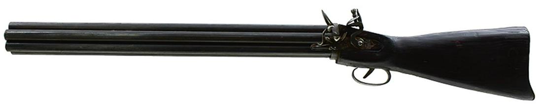 A .600 CALIBRE MODEL OF A FLINTLOCK NOCK VOLLEY GUN, the left handed gun with 24inch barrels with no: A .600 CALIBRE MODEL OF A FLINTLOCK NOCK VOLLEY GUN, the left handed gun with 24inch barrels with no touchholes, plain lock, half stocked, mounted on a wooden stand.
