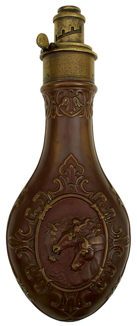 AN EMBOSSED COPPER WILD HORSES POWDER FLASK, decorated with acanthus scrolls to the reverse, the: AN EMBOSSED COPPER WILD HORSES POWDER FLASK, decorated with acanthus scrolls to the reverse, the brass top with graduated nozzle, by Hawksley, spring lacking, together with a reeded example by Hawksle