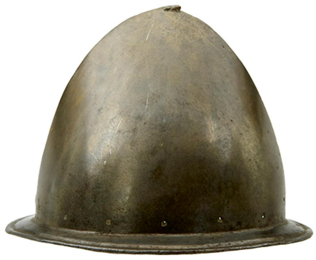 AN ITALIAN CABASET HELMET IN THE SPANISH FASHION, circa 1580, almond-shaped bowl raised from a: AN ITALIAN CABASET HELMET IN THE SPANISH FASHION, circa 1580, almond-shaped bowl raised from a single plate and with 'pear stalk' finial, distinct medial ridge, brim with turned sunken border pierced 