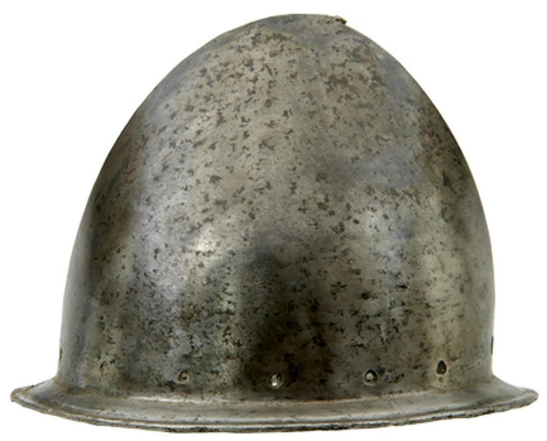 AN ITALIAN CABASET HELMET IN THE SPANISH FASHION, circa 1580, almond-shaped bowl raised from a: AN ITALIAN CABASET HELMET IN THE SPANISH FASHION, circa 1580, almond-shaped bowl raised from a single plate and with 'pear stalk' finial, distinct medial ridge, brim with turned sunken border pierced 