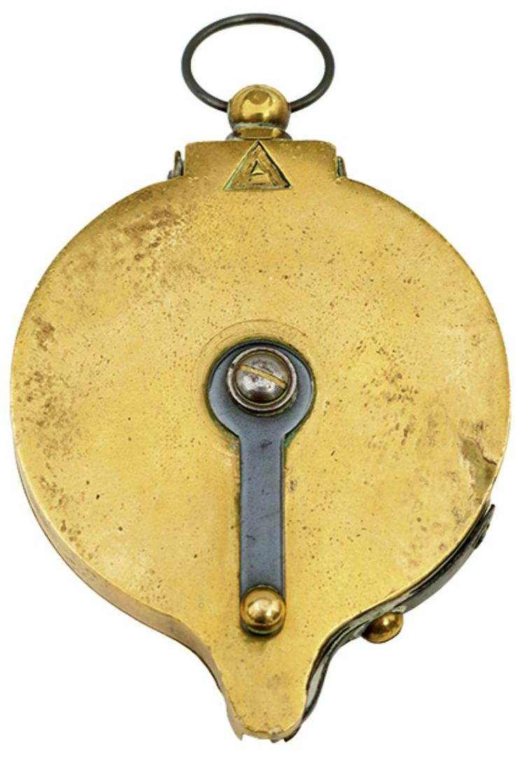 A PERCUSSION CAP DISPENSER, the large bodied brass dispenser with sprung mechanism, triangular: A PERCUSSION CAP DISPENSER, the large bodied brass dispenser with sprung mechanism, triangular maker's mark, ring swivel, together with a leather shot flask. (2)