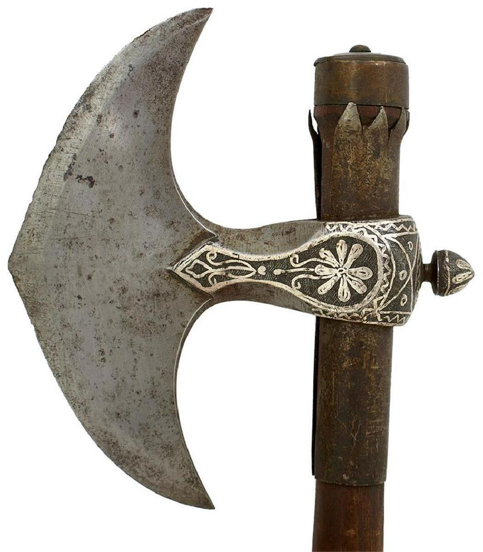 A GOOD QUALITY 19TH CENTURY INDIAN AXE, 15cm polished iron crescent-shaped head with lateral ridge,: A GOOD QUALITY 19TH CENTURY INDIAN AXE, 15cm polished iron crescent-shaped head with lateral ridge, socket thickly damascened with silver, bud-shaped peen, mounted on its wooden haft with iron reinfor