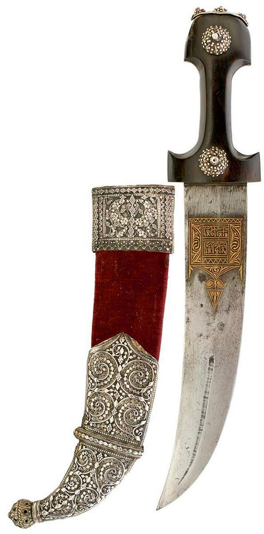 A 19TH CENTURY TURKISH OR OTTOMAN JAMBIYA, 29cm curved fullered blade inlaid in gold with a panel of: A 19TH CENTURY TURKISH OR OTTOMAN JAMBIYA, 29cm curved fullered blade inlaid in gold with a panel of geometric designs and calligraphy, characteristic carved wooden hilt with filigree pommel cap and t