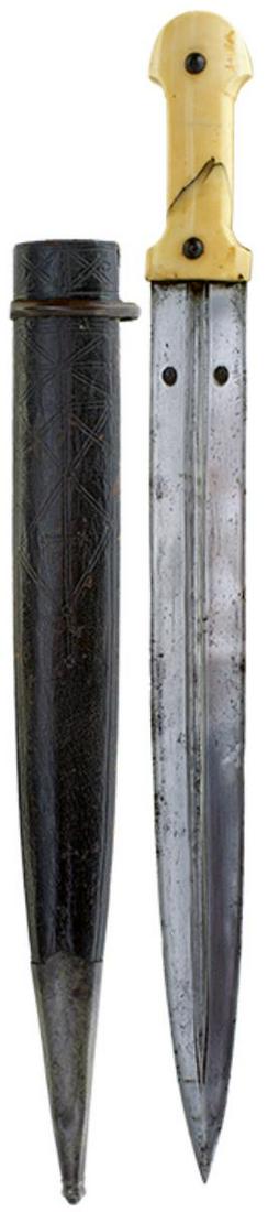 A LARGE 19TH CENTURY OTTOMAN KINDJAL, 41cm fullered blade deeply struck with two maker's marks to: A LARGE 19TH CENTURY OTTOMAN KINDJAL, 41cm fullered blade deeply struck with two maker's marks to one side, just above the forte, characteristic carved walrus hilt secured with plain domed rivets, con