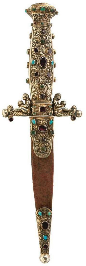 AN ORNATE 19TH CENTURY ROMANTIC DAGGER, 11cm flattened diamond section blade, tip rounded, the white: AN ORNATE 19TH CENTURY ROMANTIC DAGGER, 11cm flattened diamond section blade, tip rounded, the white metal hilt chiselled over all with scrolling foliage and flowerheads, profusely set with coloured s