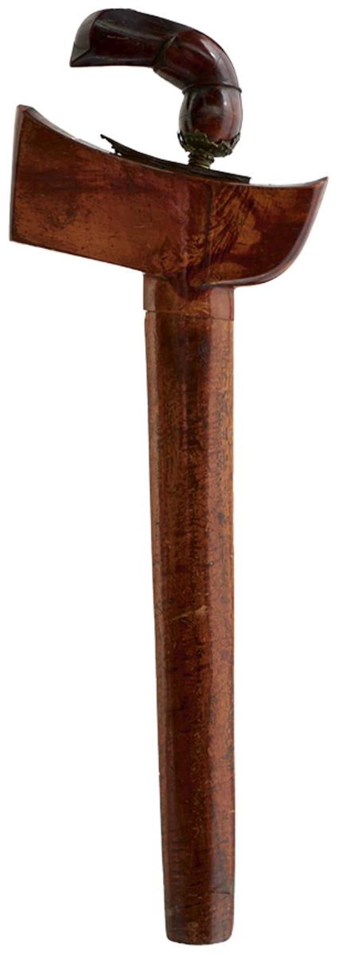 AN EARLY 20TH CENTURY MALAYAN KRIS,: AN EARLY 20TH CENTURY MALAYAN KRIS, 37cm wavy watered steel blade, the wooden hilt carved in the form of a stylized Garuda bird, contained in its polished wooden scabbard.