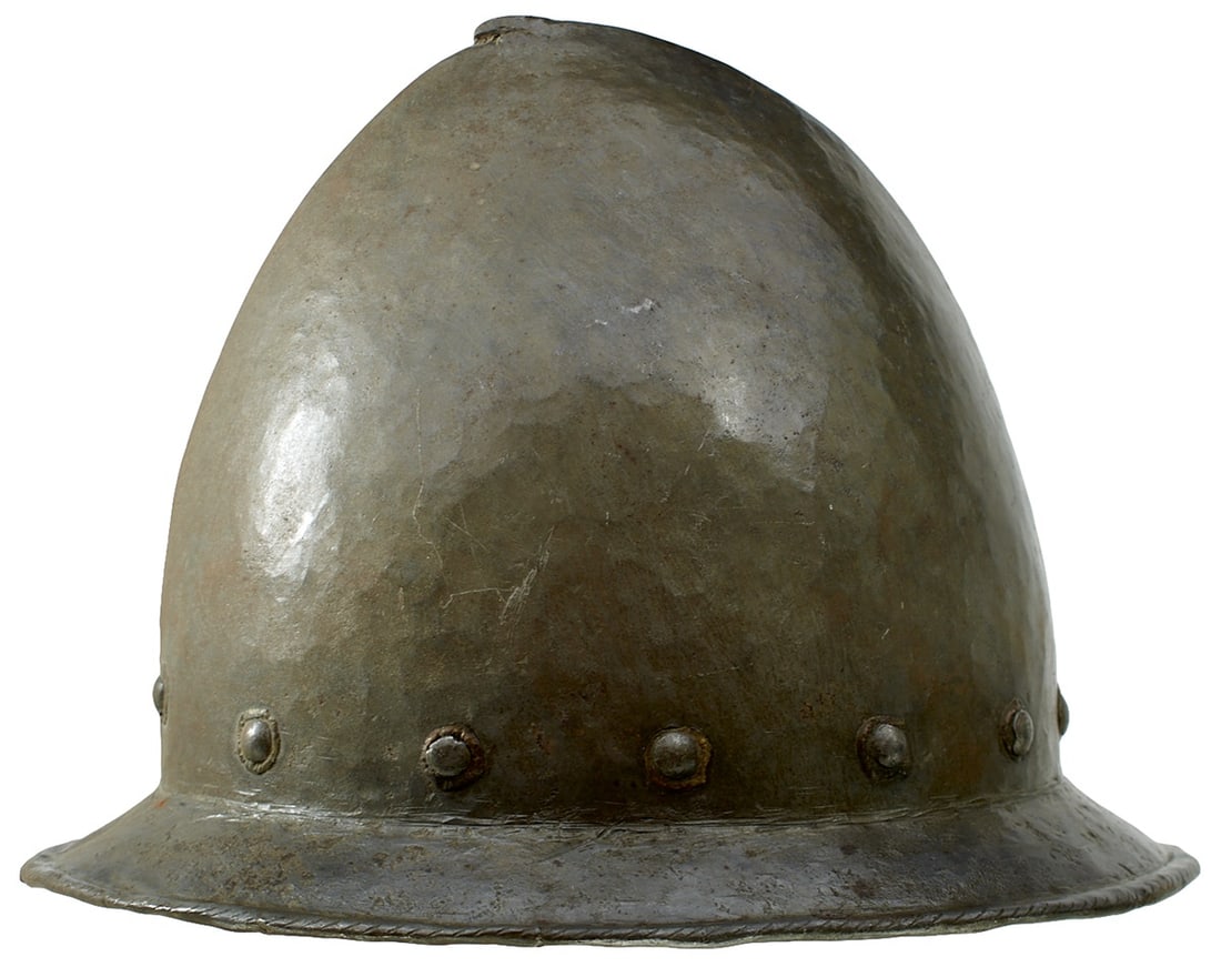 A GOOD ITALIAN CABASET, C.1580,: A GOOD ITALIAN CABASET, C.1580, raised from a single plate with hammered finish, distinct medial ridge rising to a pear stalk finial, broad brim with turned and roped edge, fitted with thirteen emboss